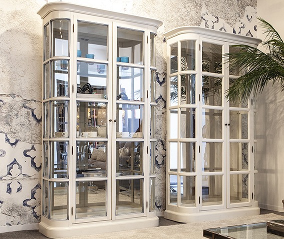 Cristal white cabinets with mirrors and white blue grey printed walls and palm plants - Original Interiors