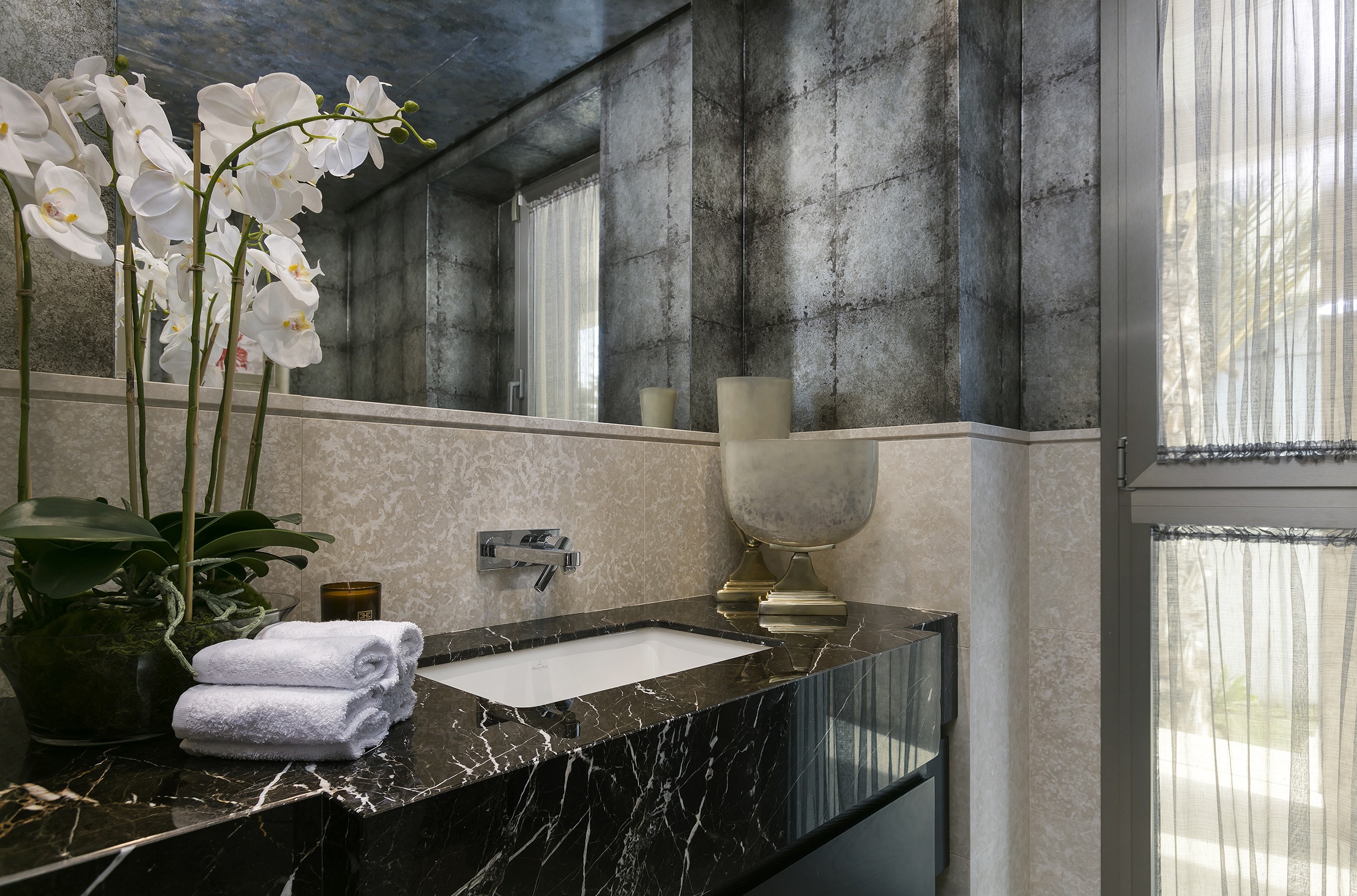Black marmer sink bathroom with grey walls and orchids luxury - Original Interiors