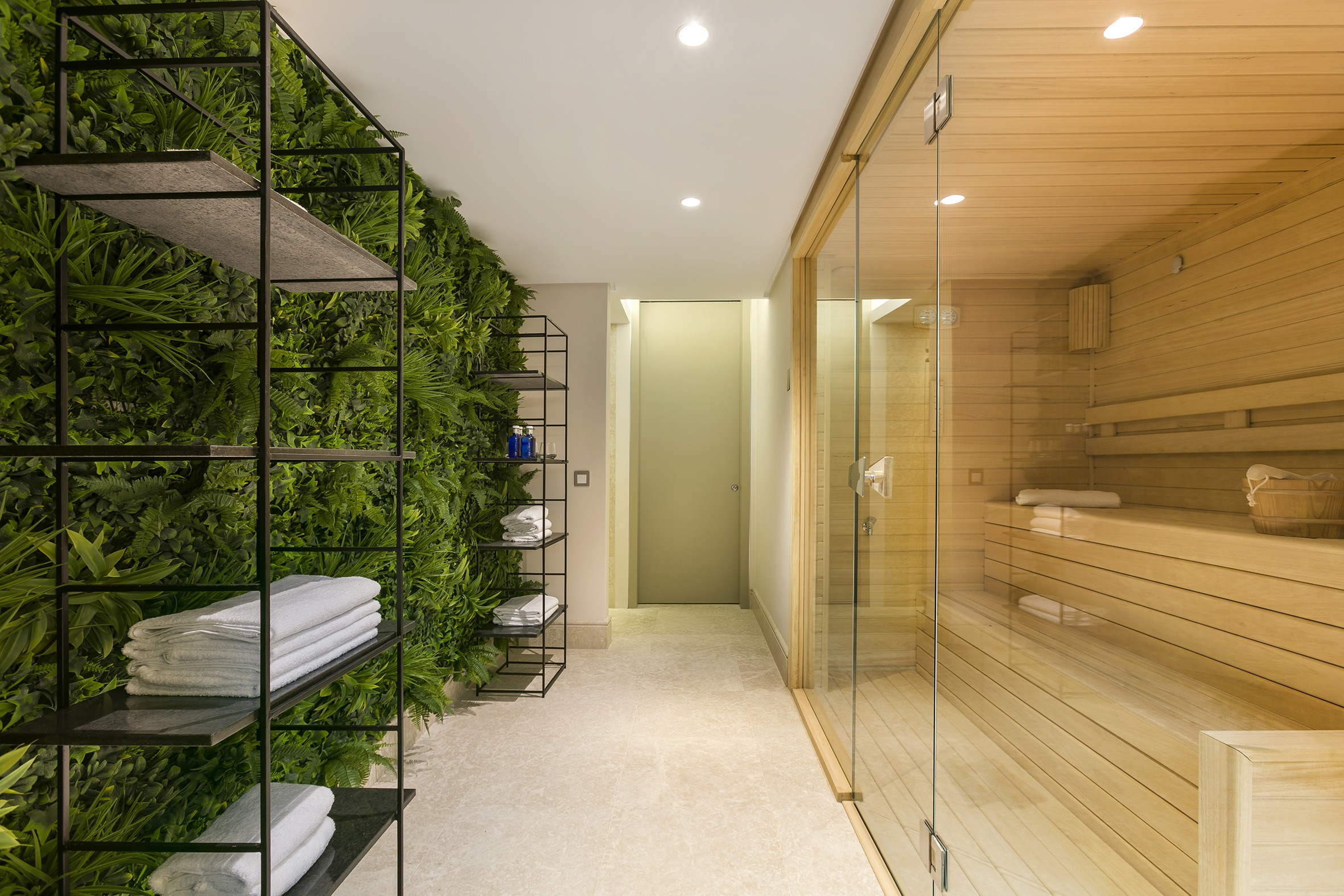 Spa Sauna are with light wood and artifical pants wall by Original Interiors