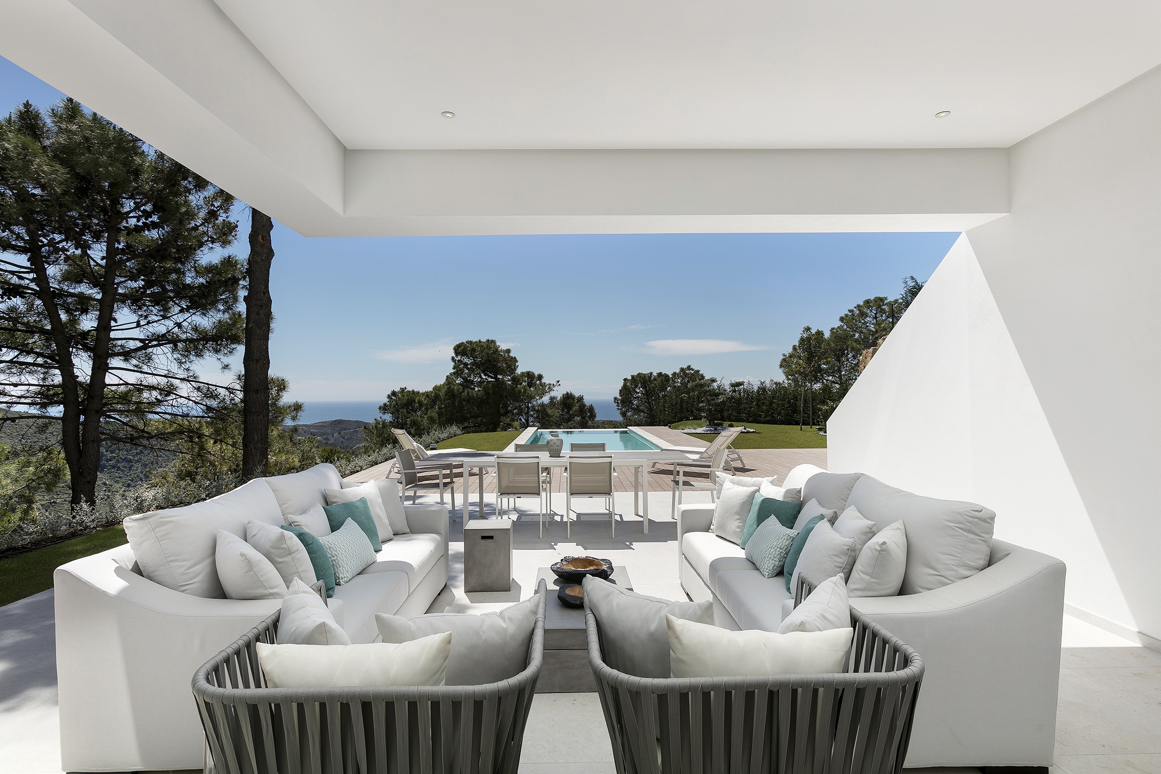 Exterior terrace design white and and grey colors , pool and ocean view - Original Interiors