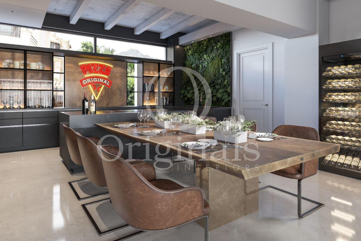 A dining area with a wooden table and brown chairs. A bar is included - Originals Interiors