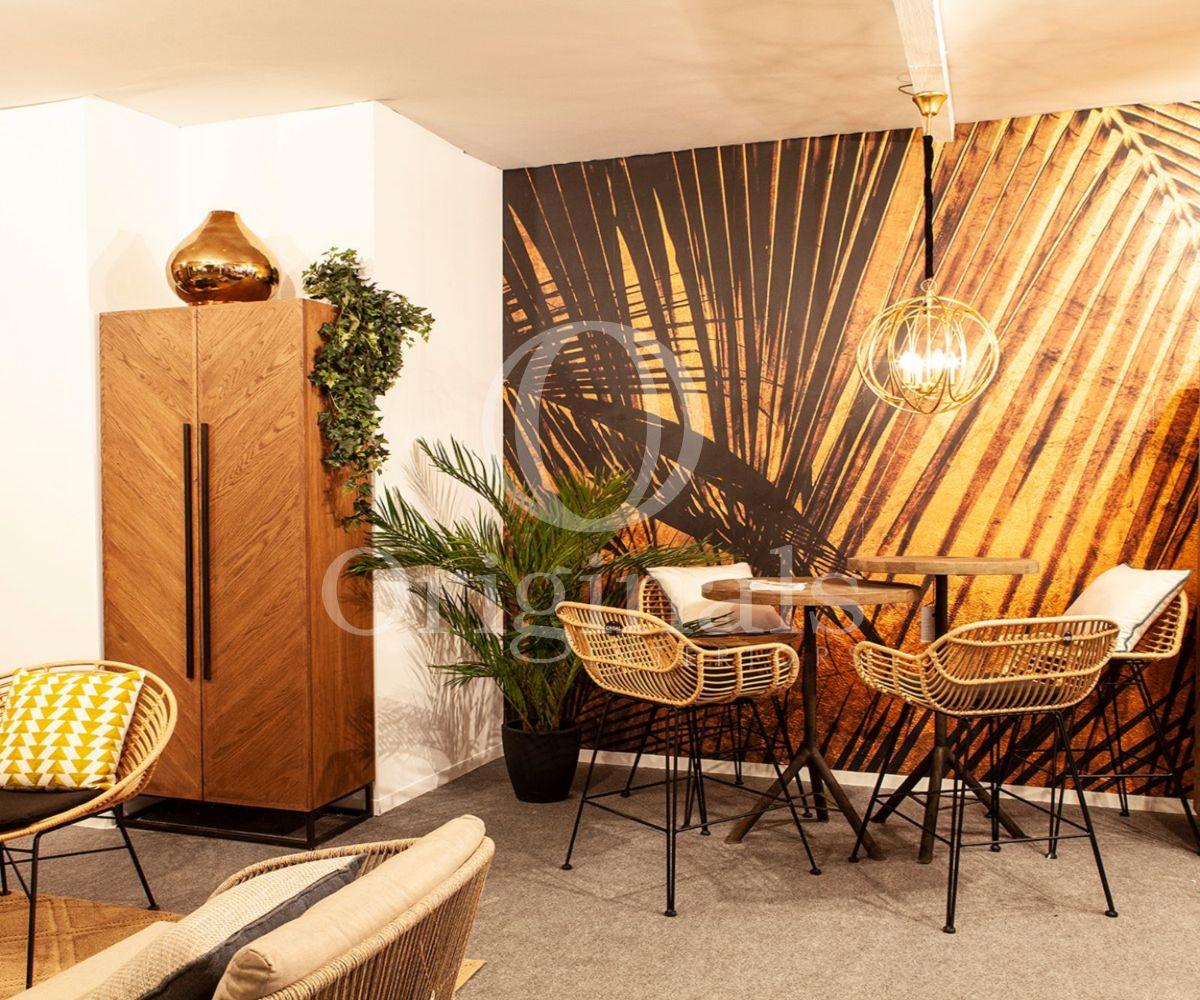 dining area with high tables and bar chairs with a palm tree wallpaper - Originals Interiors