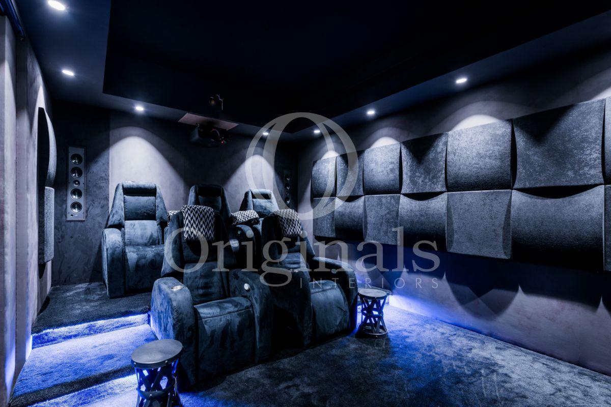 Home cinema with soft large chairs, a soft, dark blue carpet with decoration lighting - Originals Interiors