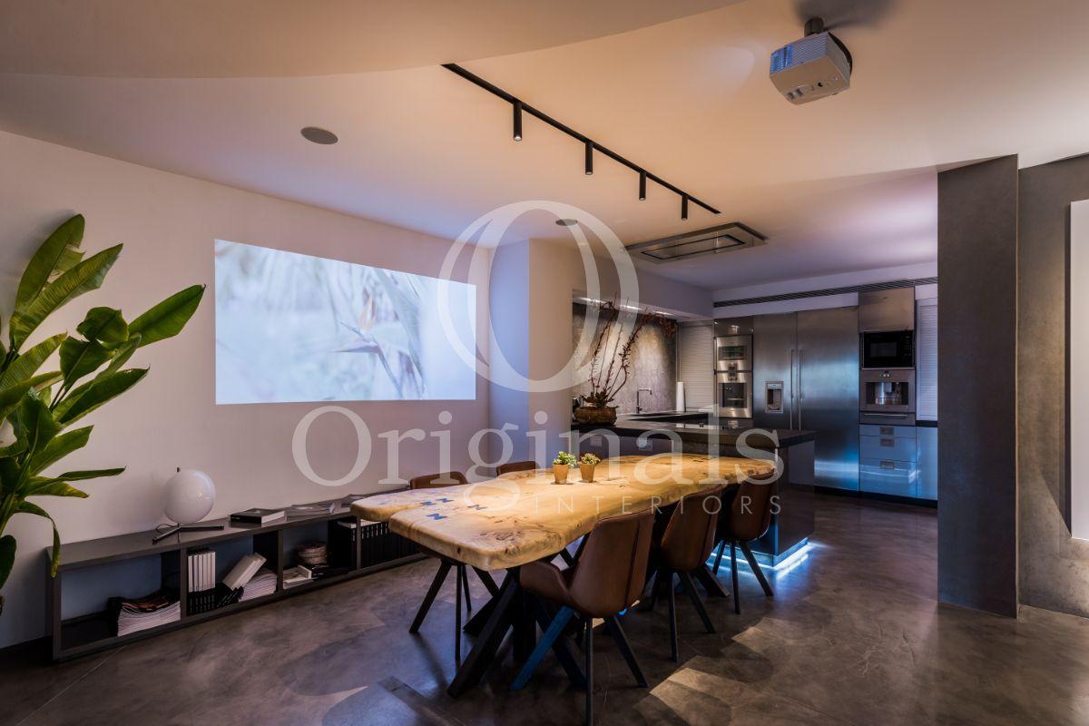 Dining area with wooden table, brown chairs and a movie projector - Originals Interiors
