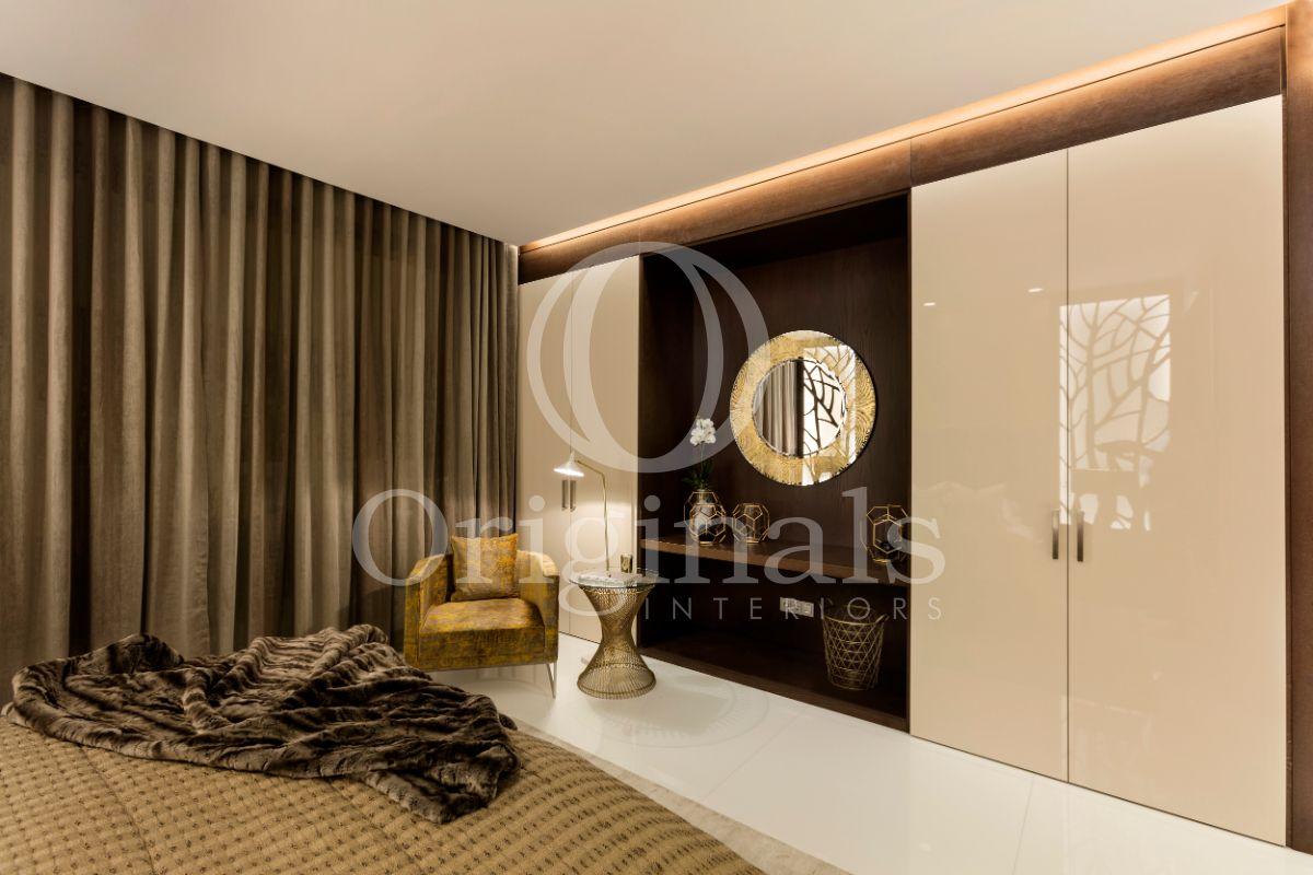 Closet with glittering white doors, roof lighting and brown green curtains - Originals Interiors