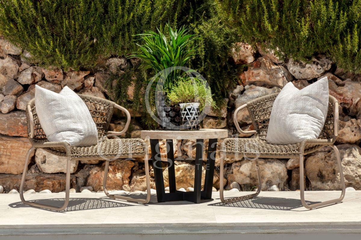 Outside lounge area with brown rope patterned chairs and a small table - Originals Interiors