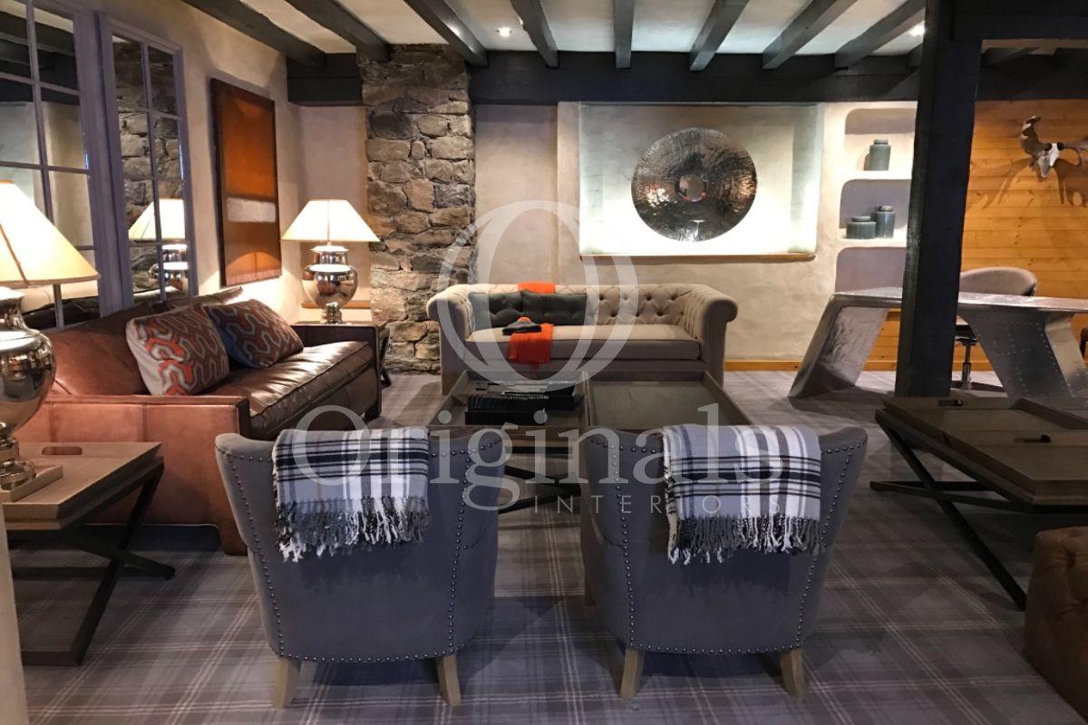 Lounge area with a grey and a red sofa and blue chairs - Originals Interiors