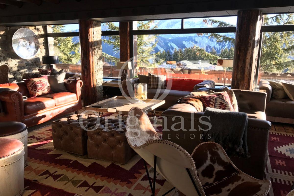 Lounge area with mountain view with red sofas and animal printed furniture - Originals Interiors