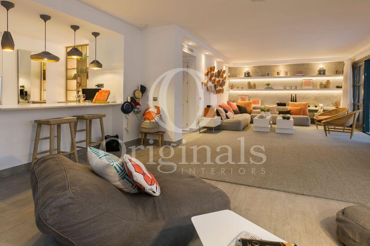 Living room with grey bean bags and a storage shelve with back lighting - Originals Interiors
