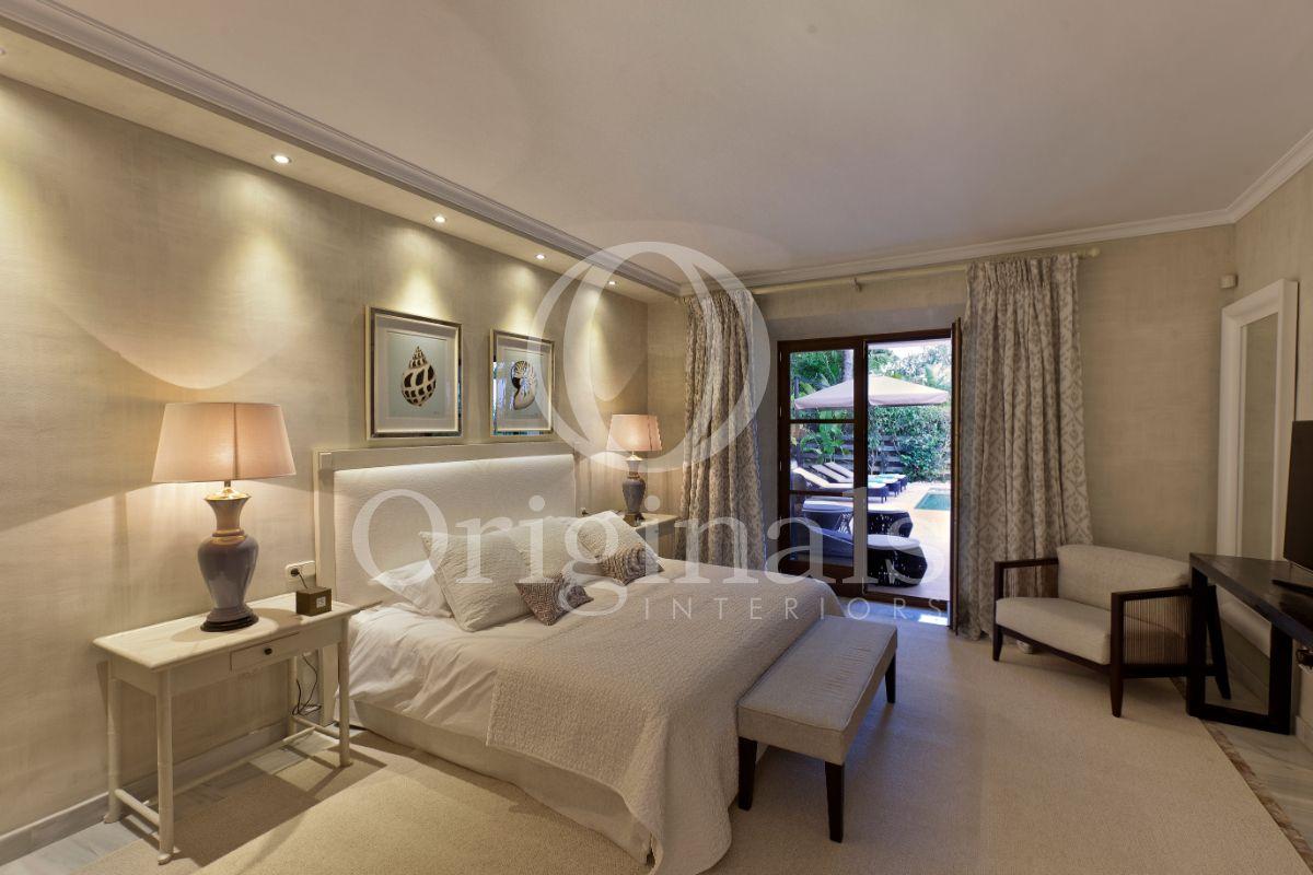 Bedroom with beige shelves, lamps and wallpaper - Originals Interiors