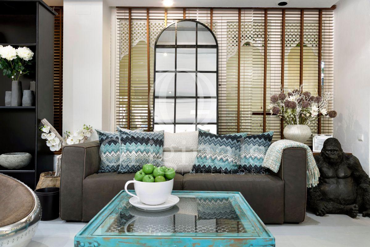 Lounge area with dark sofa and a turquoise coffee table - Originals Interiors