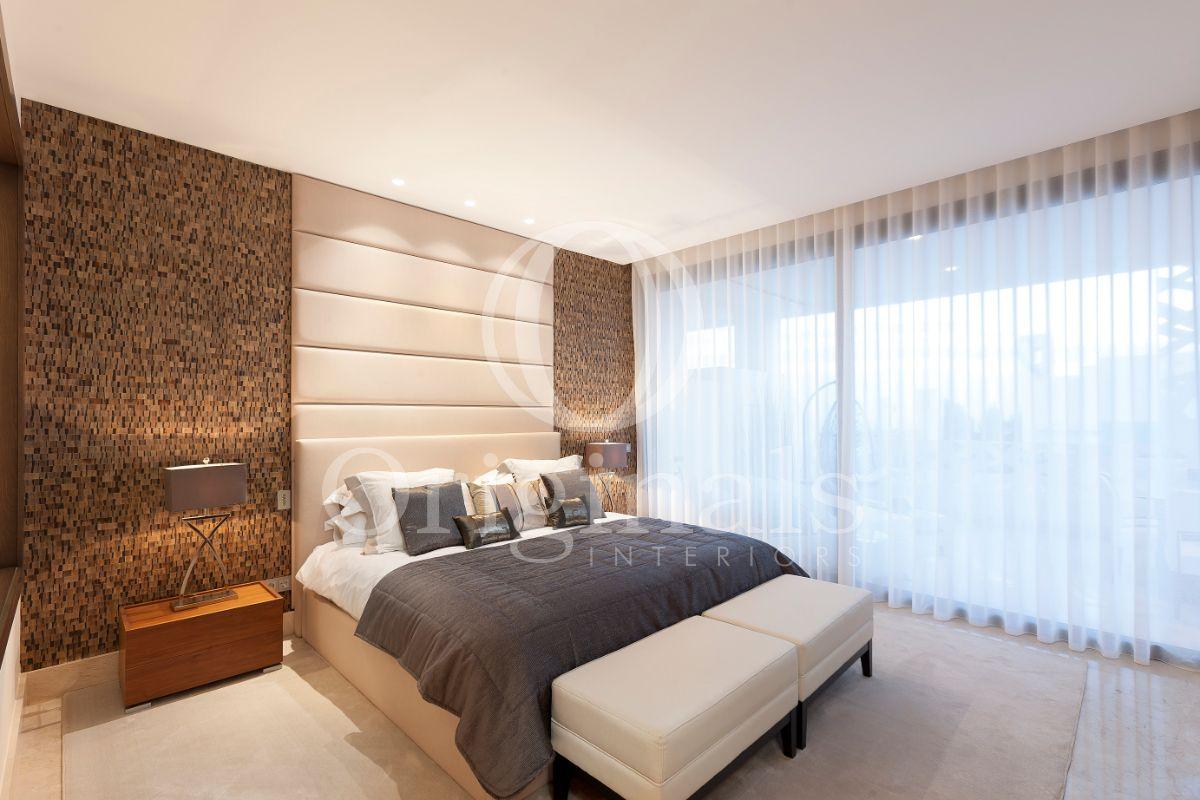 Bedroom with brown mosaic background and beige decoration - Originals Interiors