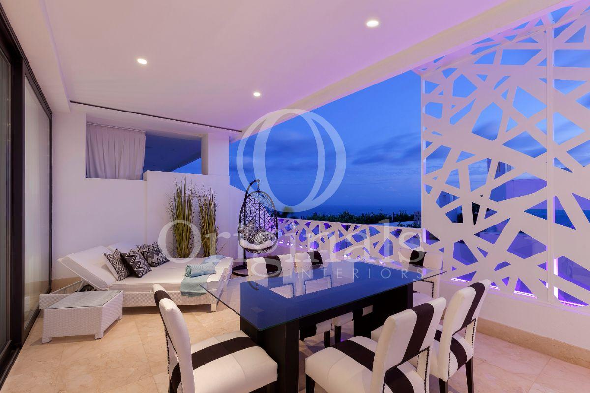 Outside lounge area with artwork, a glass table with white chairs and a hanging chair - Originals Interiors