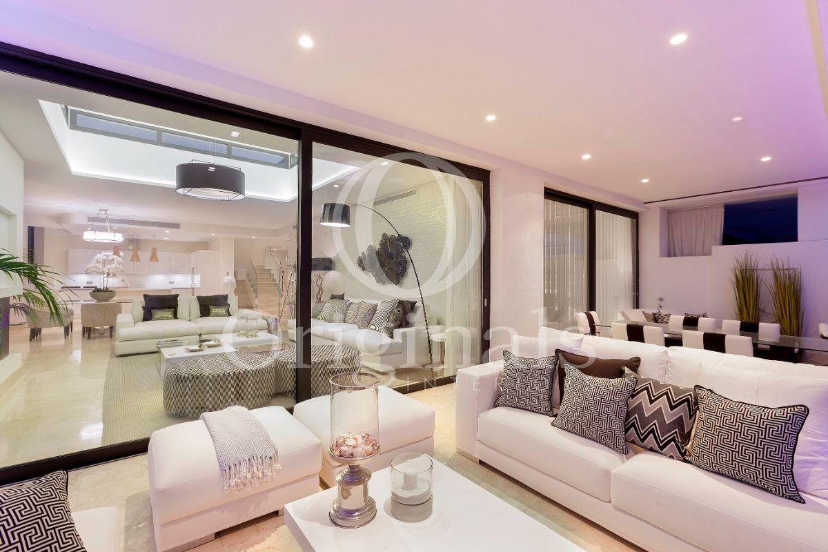 Outside lounge area with white sofas and large glass windows - Originals Interiors