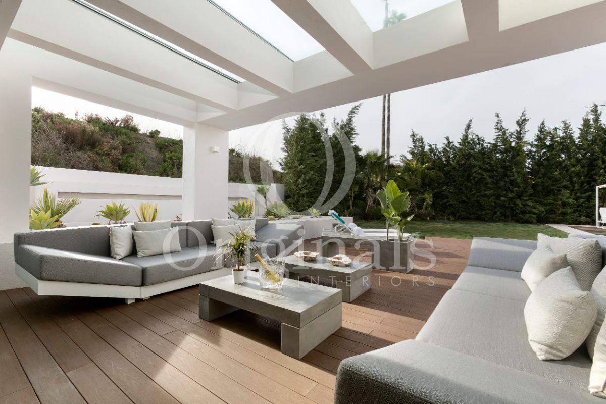 Outside lounge area with grey sofas and a wooden floor - Originals Interiors