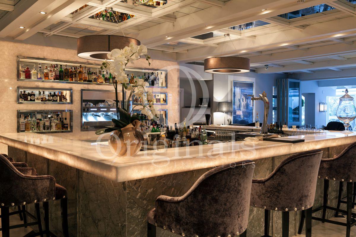 Bar made out of marble with mirror roofing and decorative lighting - Originals Interiors