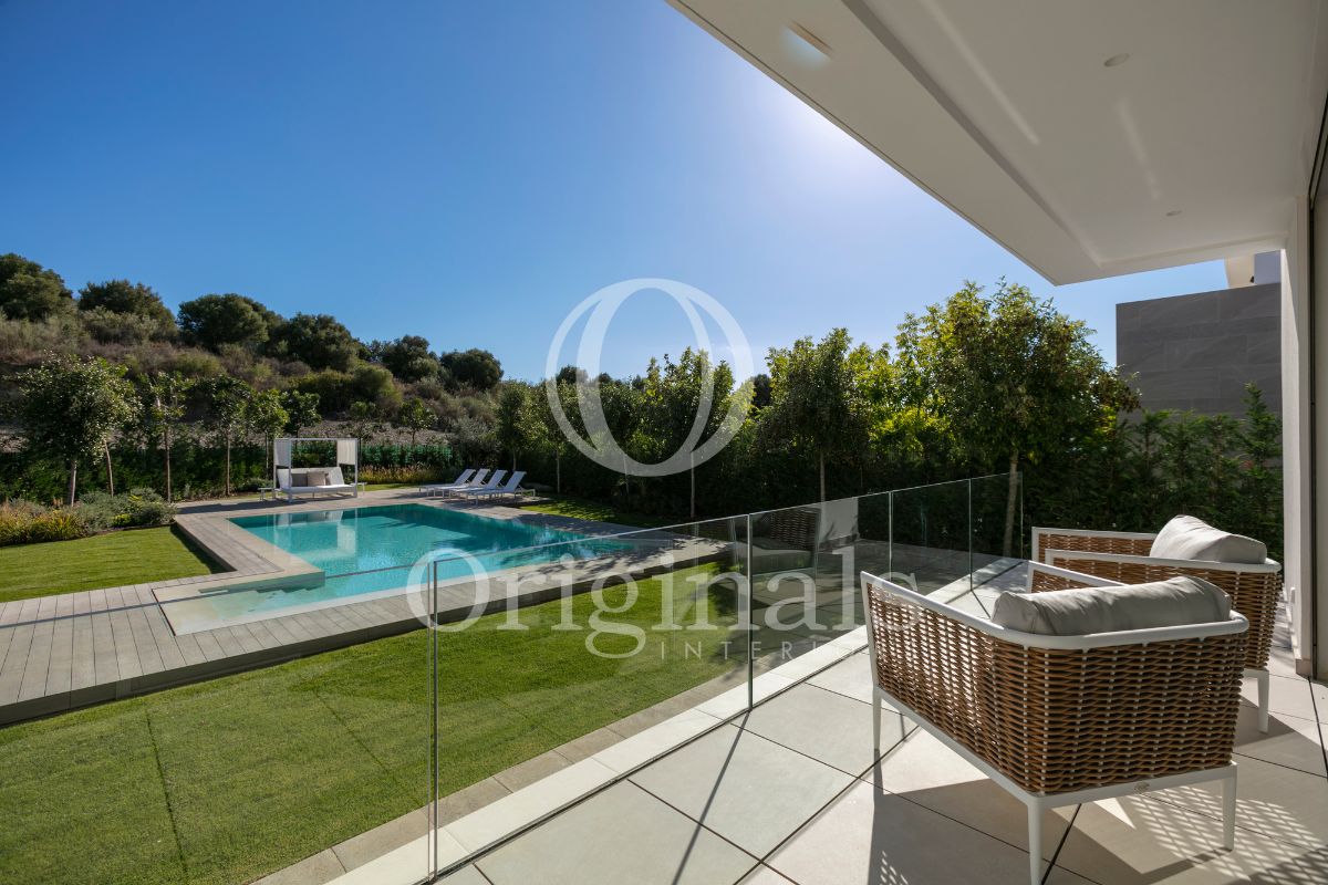 Furnished terrace with garden and pool view surrounded by nature - Originals Interiors