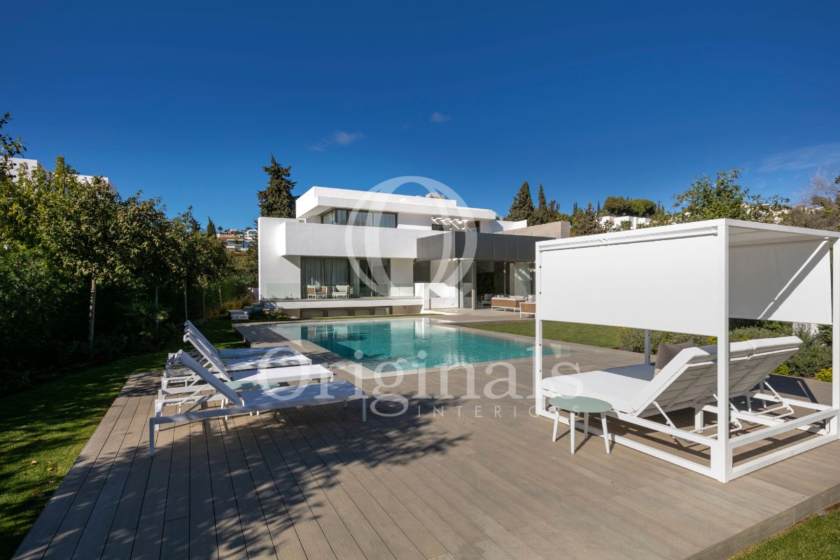 White luxurious property with pool area and white outdoor forniture - Originals Interiors